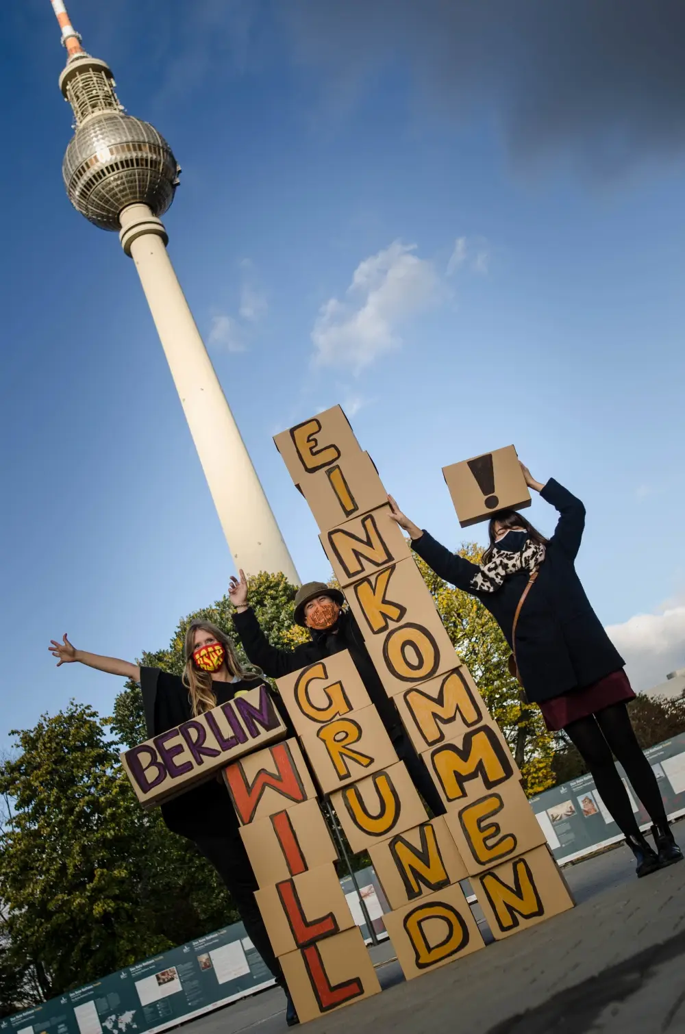 Mitglieder der Expedition Grundeinkommen posieren mit Pappkartons, deren Aufschrift den Satz "Berlin will Grundeinkommen" ergibt.